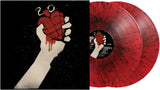 Vinyl record with a hand holding a heart design on a black background