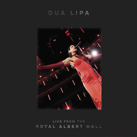 Dua Lipa performing live at the Royal Albert Hall with a dark background