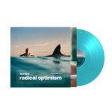 Dua Lipa in the water with a shark fin in the water at sunset showing the Blue Vinyl