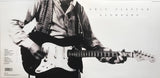 Folded out cover of 'Slowhand' by Eric Clapton featuring a black and white photo of Clapton playing guitar.