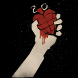 Heart-shaped grenade held by a hand on a black background