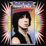 Iggy Pop 'Instinct’ album cover artwork featuring a portrait of Iggy Pop centered within a colourful starburst frame on a black background.