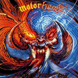 Motorhead 'Another Perfect Day’ album cover artwork featuring a stylised, highly detailed illustration of a demonic or monstrous face with glowing red eyes, sharp teeth, and swirling orange flames against a blue background.
