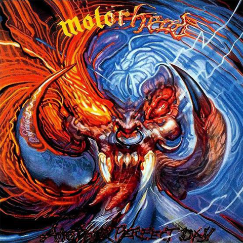 Motorhead 'Another Perfect Day’ album cover artwork featuring a stylised, highly detailed illustration of a demonic or monstrous face with glowing red eyes, sharp teeth, and swirling orange flames against a blue background.