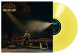 Vinyl record with concert scene on cover, featuring a yellow disc.