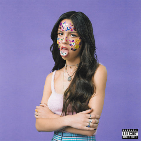 Olivia Rodrigo with floral stickers on her face against a purple background