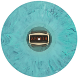 A circular turquoise and teal marbled VInyl with a central digital display showing the time 22:58:15.9 in orange-red digits.
