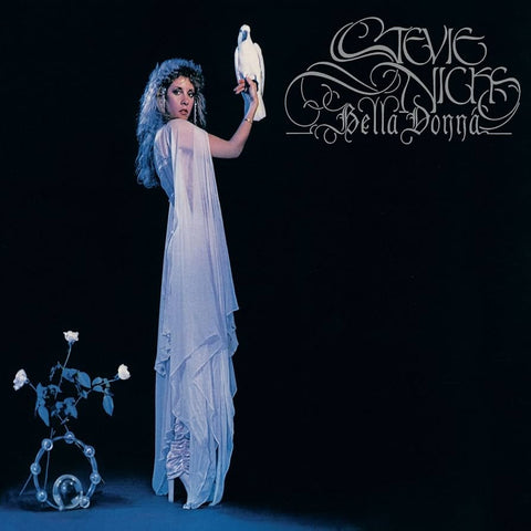 Album cover with Stevie Nicks in a white dress holding a bird, against a dark background.