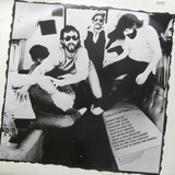 The Doobie Brothers band members in a group photo with album track listing