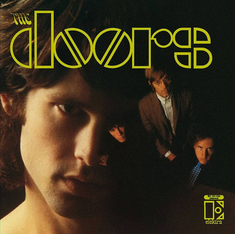 Album cover for 'The Doors' with a close-up of a person's face and the band members in the background.