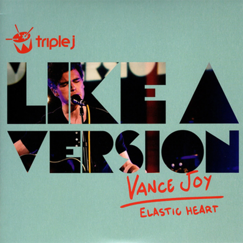Album cover for 'Like a Version' by Vance Joy from the album 'Elastic Heart', featuring a light teal background with bold black and red typography and a photo of the singer in the lettering.
