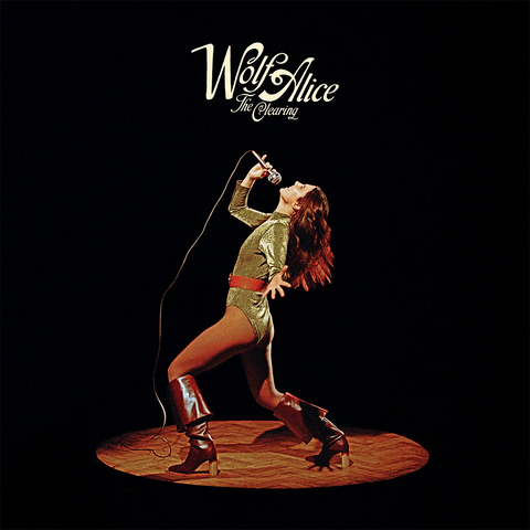 Album cover for 'Wolf Alice' featuring a performer in a spotlight with the band's name above.