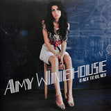 Amy Winehouse Back To Black Front Cover with Amy Sitting a stool in front of a chalk board
