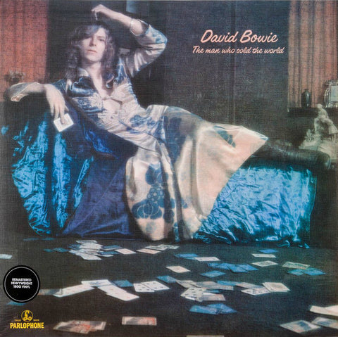 David Bowie The Man Who Sold The World Front Cover with Bowie laying on a couch in a white floral dress