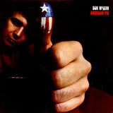 The image displays the cover of Don McLean's album 'American Pie.' It features a close-up of a hand making a fist, with a close-up of a person's face in the background, partially obscured by the hand.