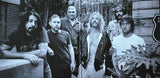 Black and white collage of the Foo Fighters with a brick wall and plant in the background