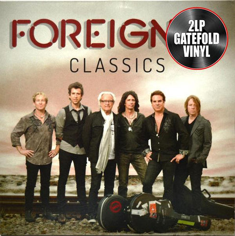 The image shows the cover of the 'FOREIGNER - CLASSICS' album, featuring a group of musicians from the rock band Foreigner, in a gatefold vinyl format.