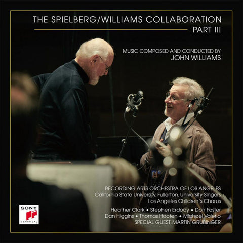 Cover of the album 'The Spielberg/Williams Collaboration Part III' featuring Spielberg and Williams in a studio setting, with one playing a musical instrument and the other conducting.