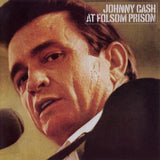 Cover of the album 'At Folsom Prison' by Johnny Cash, featuring a close-up of his face with a microphone in the foreground.