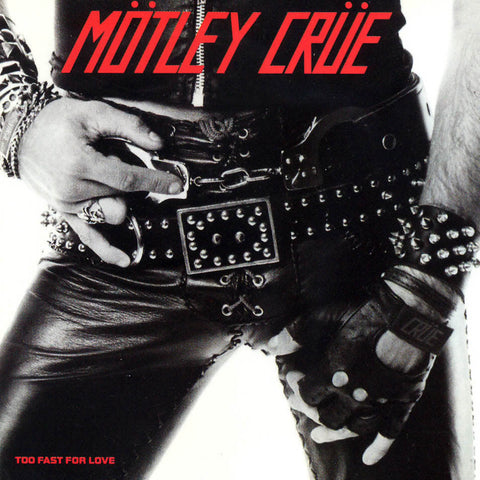 The album cover depicts a bold and distinctive image of the band's frontman, with a close-up on his leather-gloved hand and the details of his belt and buckle, which are prominently displayed.
