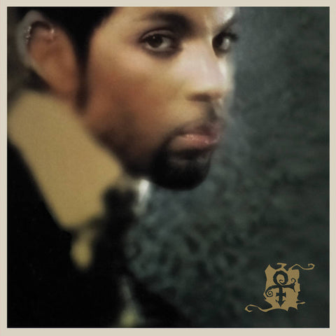 Album cover art featuring a close-up of Prince's face with a dark, textured background.
