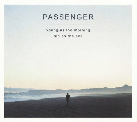 A person standing on a beach looking out towards the ocean, with the text 'PASSENGER young as the morning old as the sea' overlaid on top.