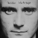 Black and white cover art of Phil Collins for the single 'In the Air Tonight'. The image features a close-up of Collins' face with the title text