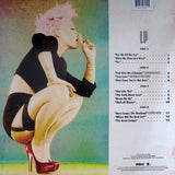 This image features the back cocver for Pink The Truth About Love The Back cover is vibrant and colourful, with P!NK depicted in a bold pose against a textured, gridded background. With track listing