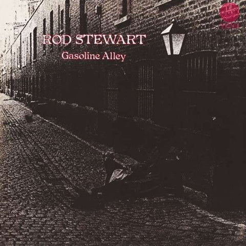The cover image shows a black and white photo of a street scene with a sign that reads 'ROD STEWART' and the album title 'Gasoline Alley'. The photo captures a quiet, dimly lit alleyway with a street lamp and brick walls.