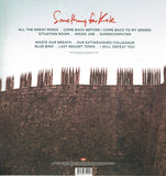 Back Cover with band name in red and track listing in dark text against a photo of a castle wall