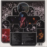 Back Cover of album with live images of the band and a track listing in white text on a black background