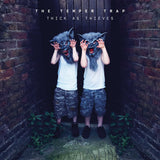 Limited edition coloured vinyl record of 'The Temper Trap - Thick as Thieves'. The cover features two kids wearing wolf masks, standing in a dimly lit space with a brick wall backdrop.
