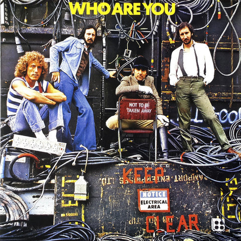 The cover artwork for 'Who Are You' album by The Who, featuring members of the band with a backdrop of electrical wiring and a chair with the text 'Not To Be Taken Away'.