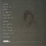 A black and white image of a lady with a track listing in white text